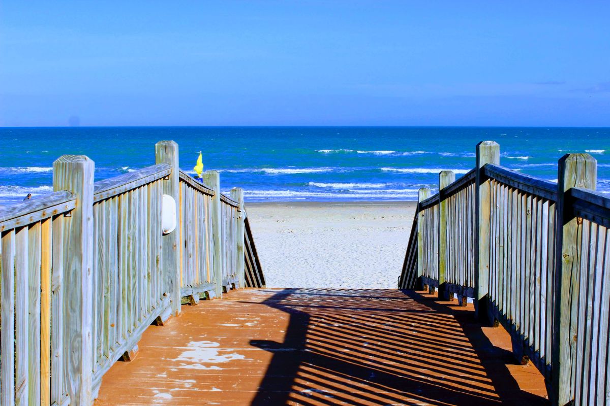 Wooden boardwalk leading to the beach, a starting point for eco tours south padre island.