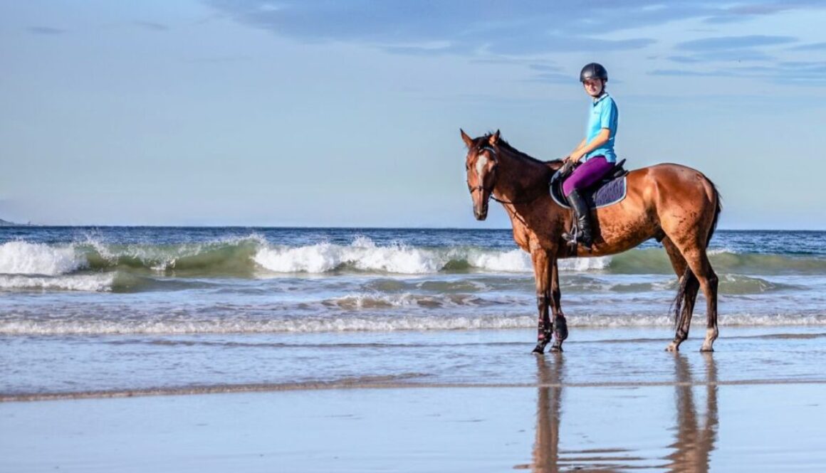 The man was riding a horse on the beach of South Padre Island.