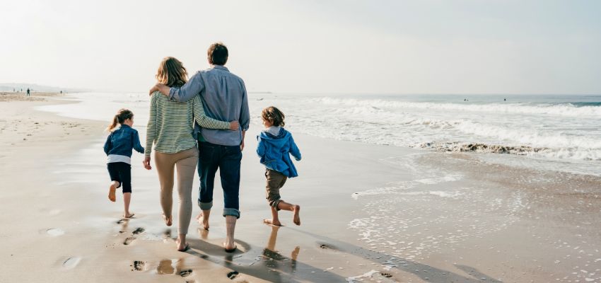 A family walking together on the beach of South Padre Island.