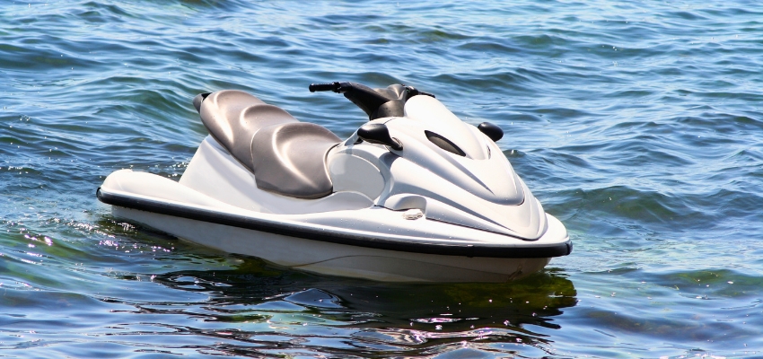 White jet ski floating on calm water, ready for a lesson on how to drive a jet ski.