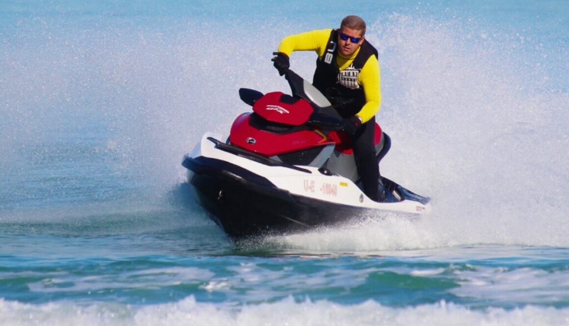 Experienced rider cutting through waves, showing advanced techniques for how to drive a jet ski.
