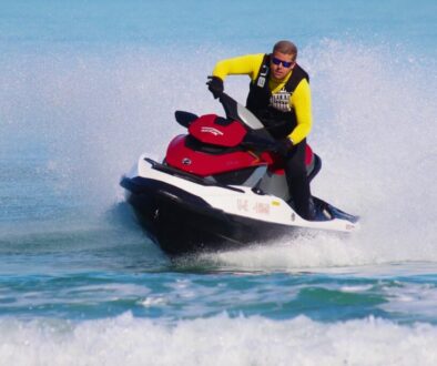 Experienced rider cutting through waves, showing advanced techniques for how to drive a jet ski.