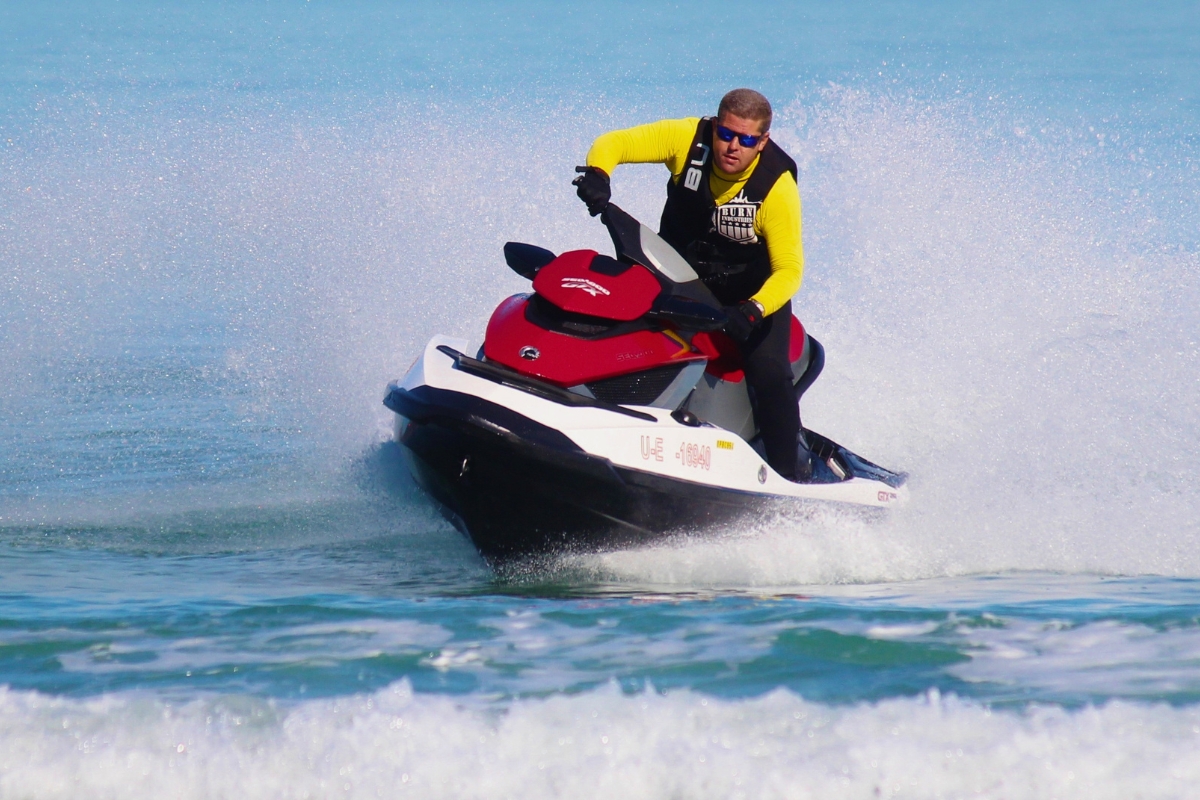 Experienced rider cutting through waves, showing advanced techniques for how to drive a jet ski.