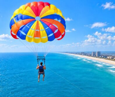 Parasailer soaring high above the ocean, showing how high is parasailing in practice.